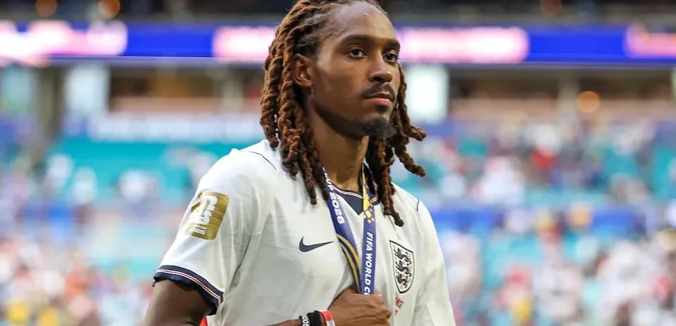 Player walking off the pitch with medal after match