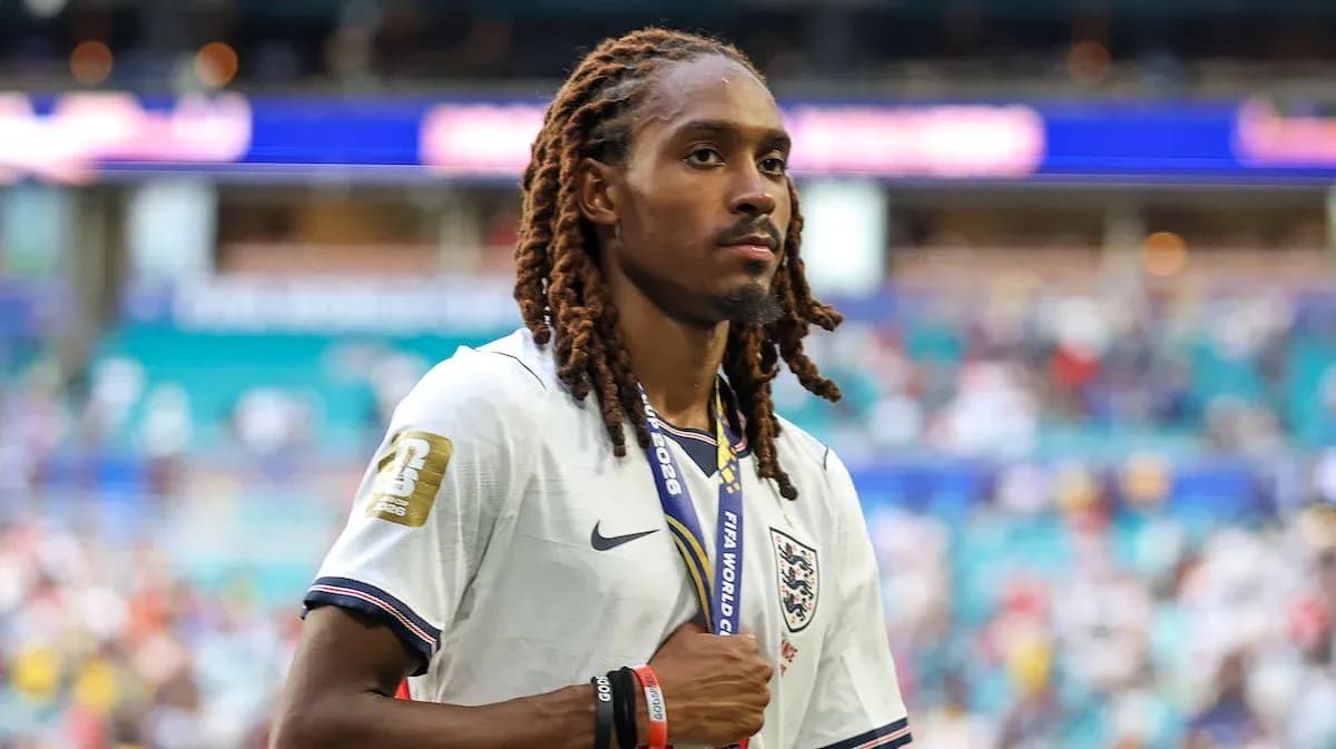 Player walking off the pitch with medal after match