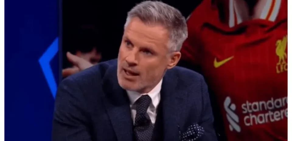 Analyst discussing football in front of Liverpool jersey