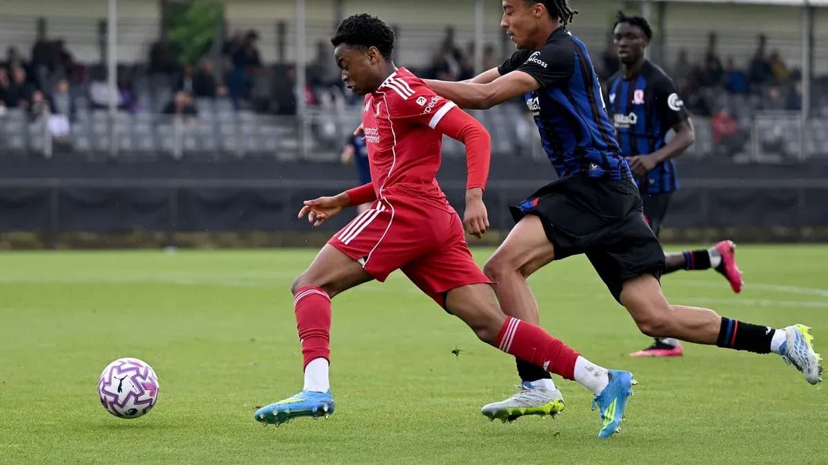 Player in red jersey evading opponent during match