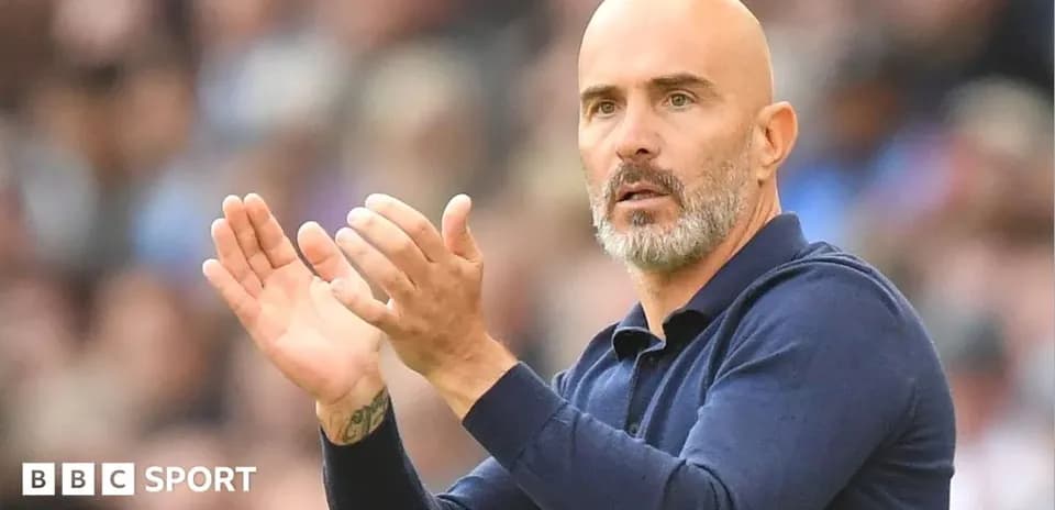 Coach gesturing and applauding during match