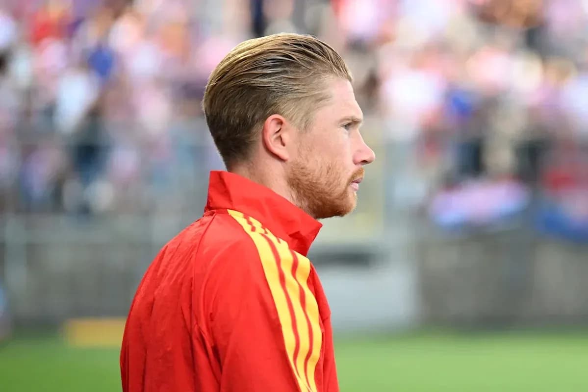 Player in red jacket looking at the field