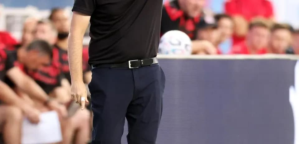 Coach giving instructions from the sidelines during match