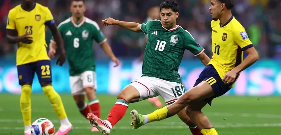 Mexico player challenges Ecuador player during match