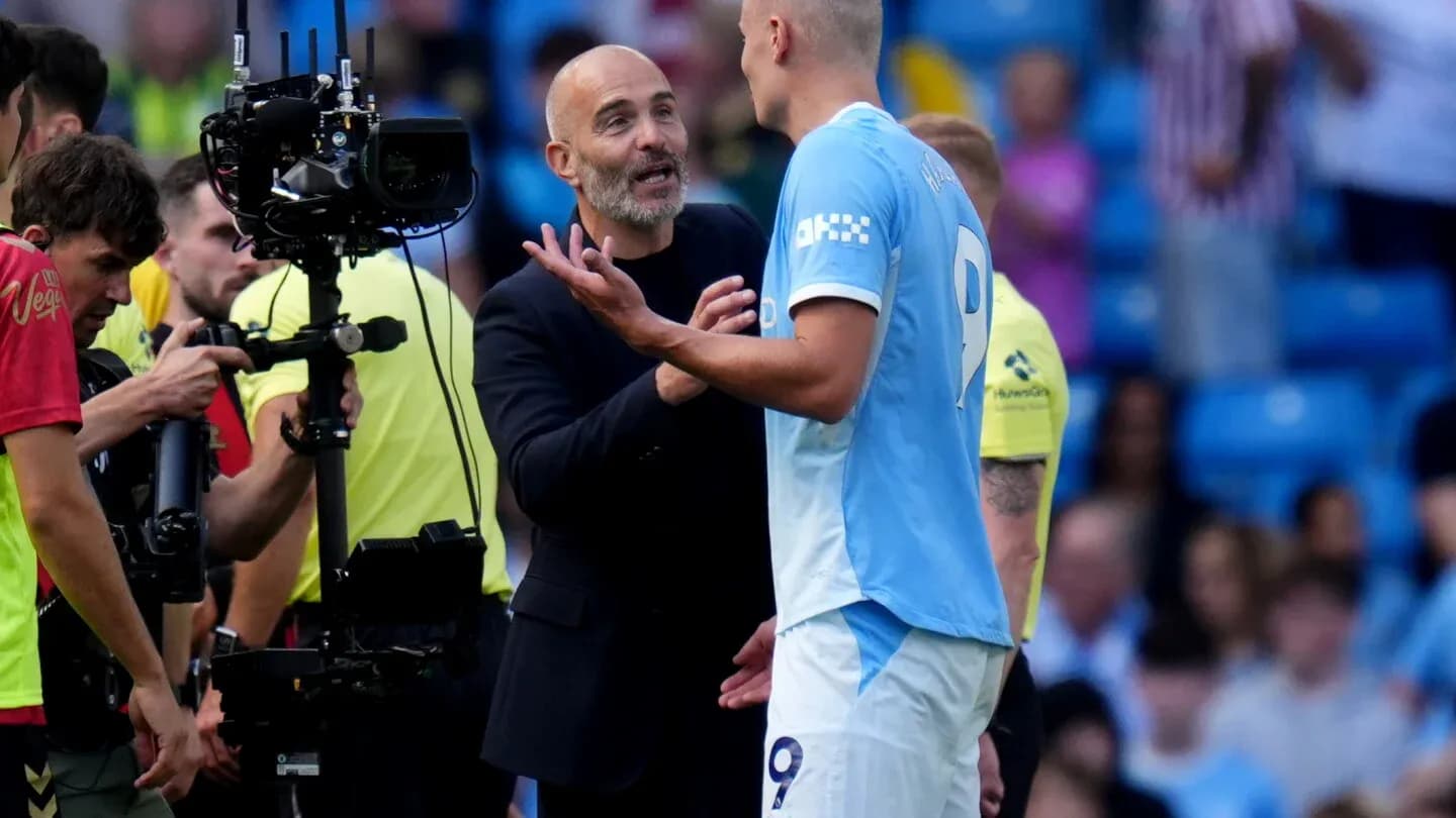 Coach discussing with player during match stoppage