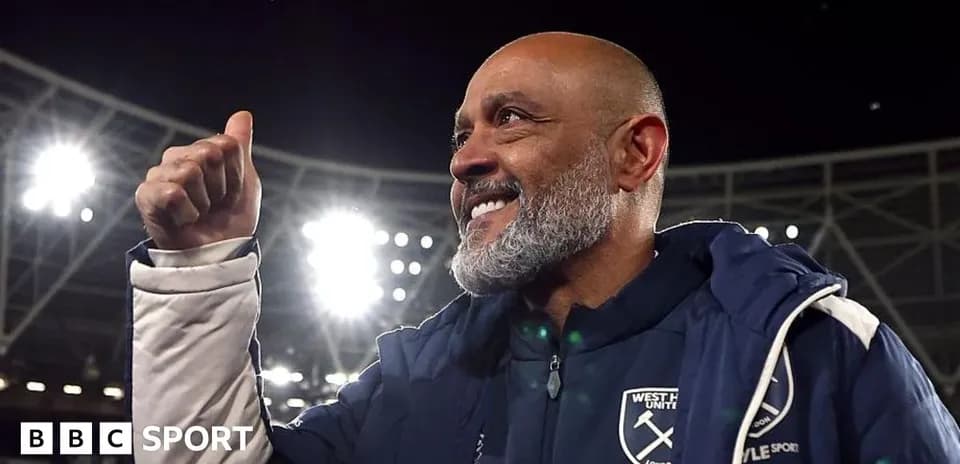 Coach celebrating with a thumbs-up gesture