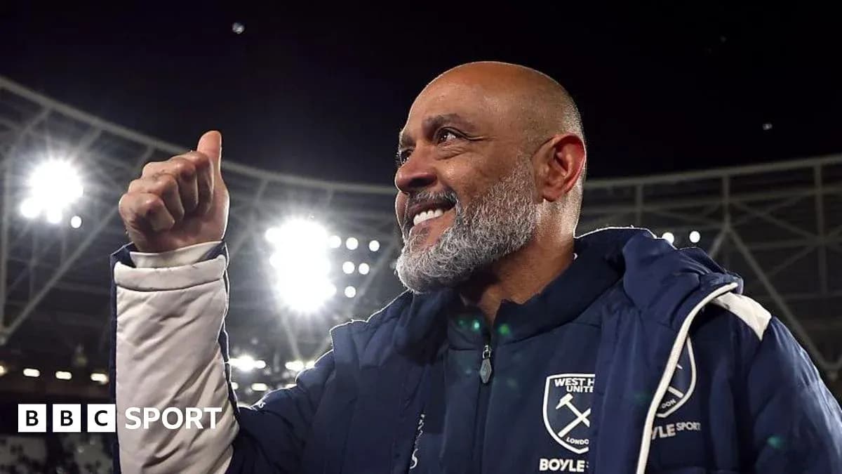 Coach celebrating with a thumbs-up gesture