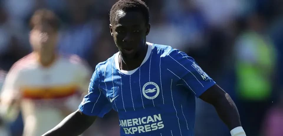 Player in blue kit dribbling the ball during match