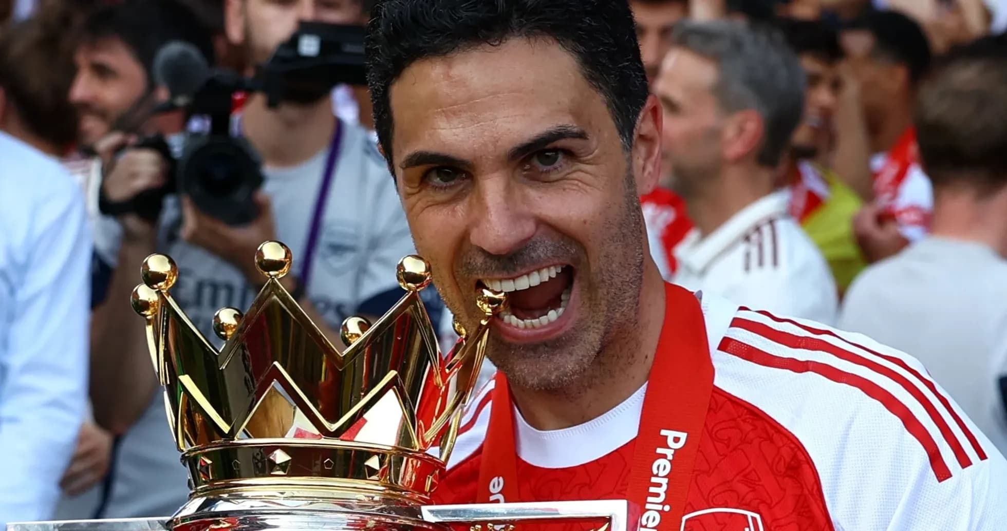 Manager holding Premier League trophy in celebration