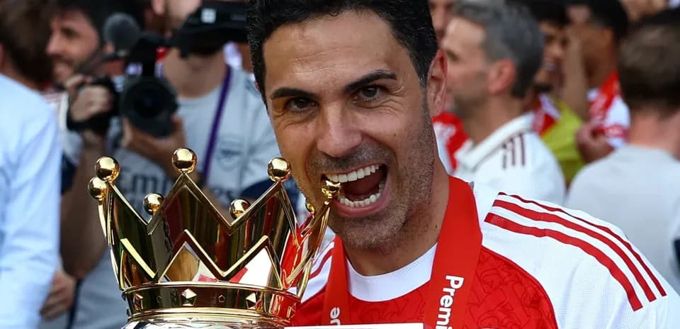 Manager holding Premier League trophy in celebration