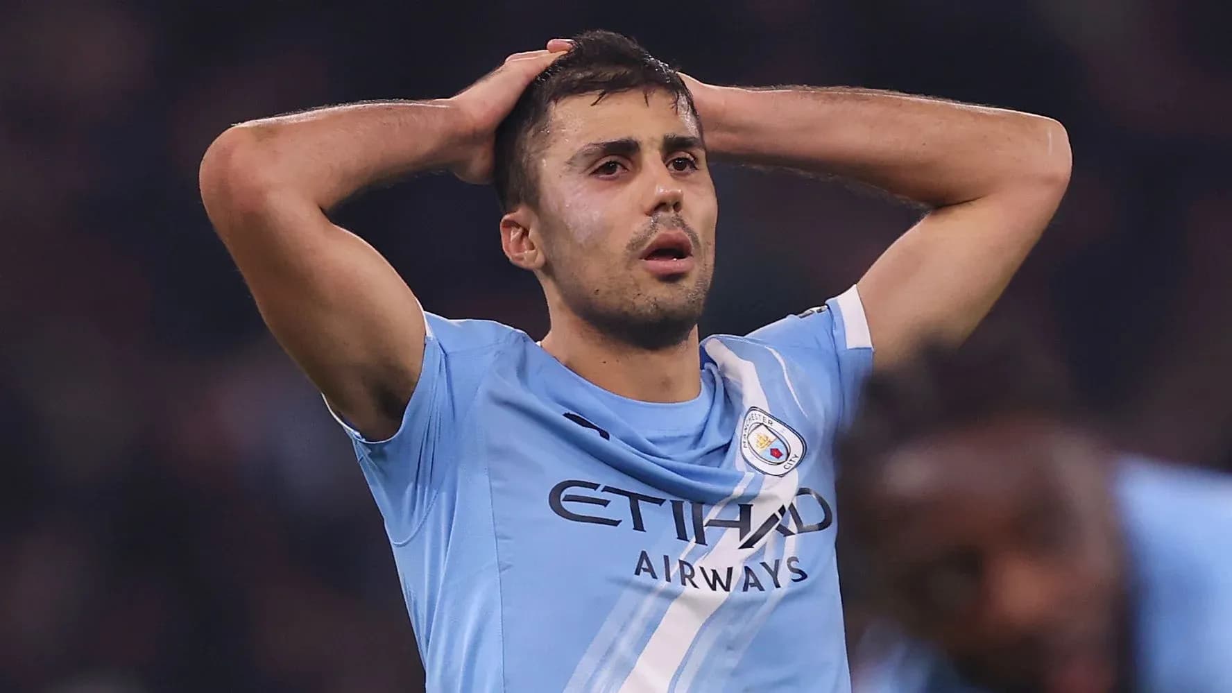 Player holding head in disappointment on the pitch