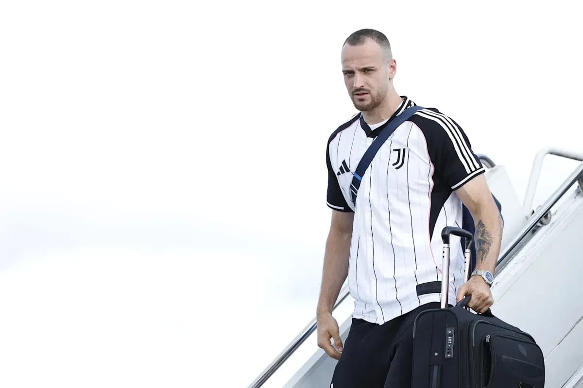 Player arriving with suitcase after flight