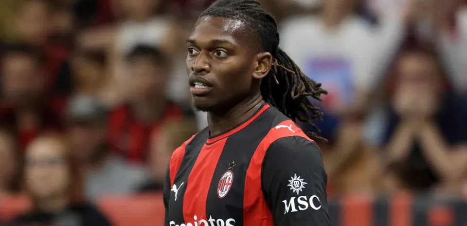 AC Milan player during match with fans in background