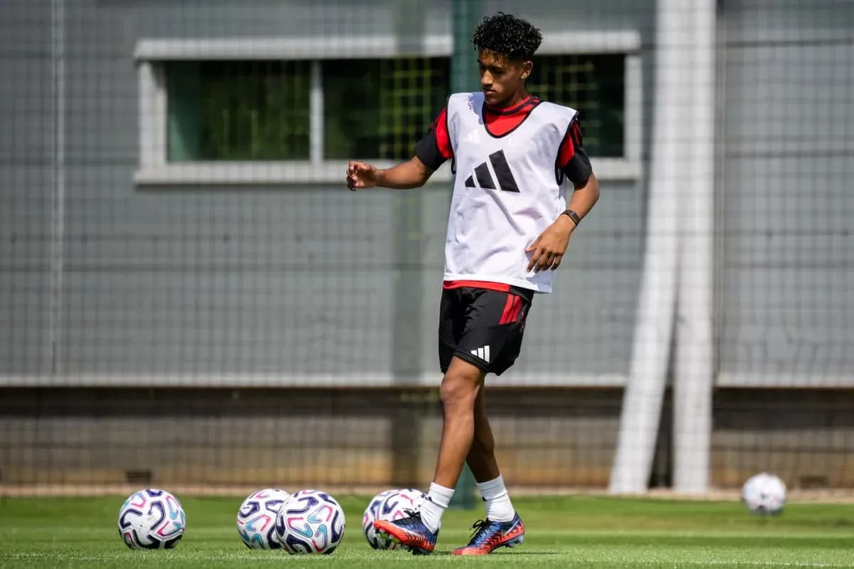 Player training on pitch with multiple soccer balls