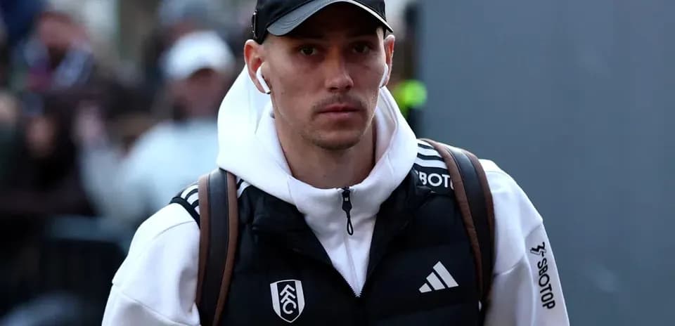 Player walking with headphones and backpack before match