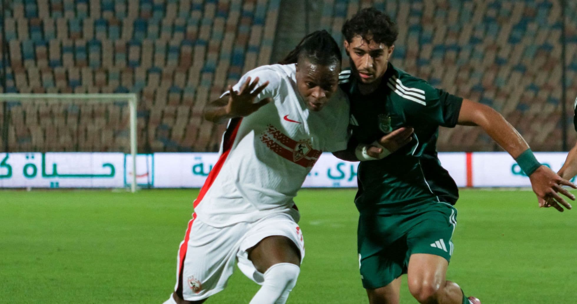 Two players competing for the ball during match