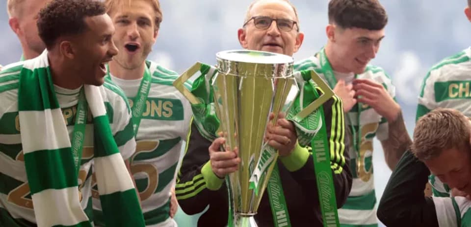 Celtic team celebrating with trophy after victory