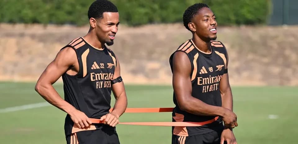 Two players training with resistance bands on field
