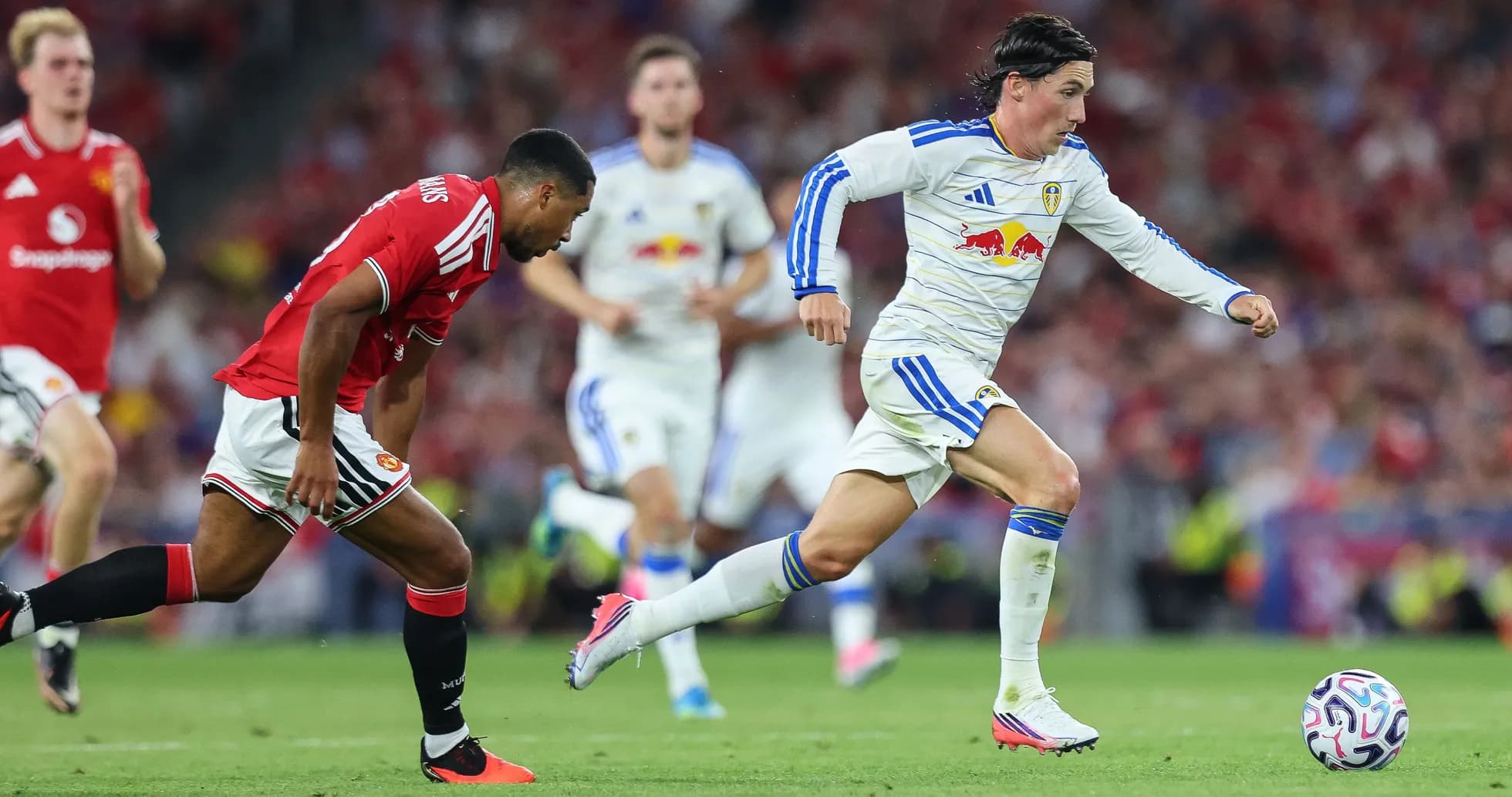Leeds player sprinting past Manchester United defender