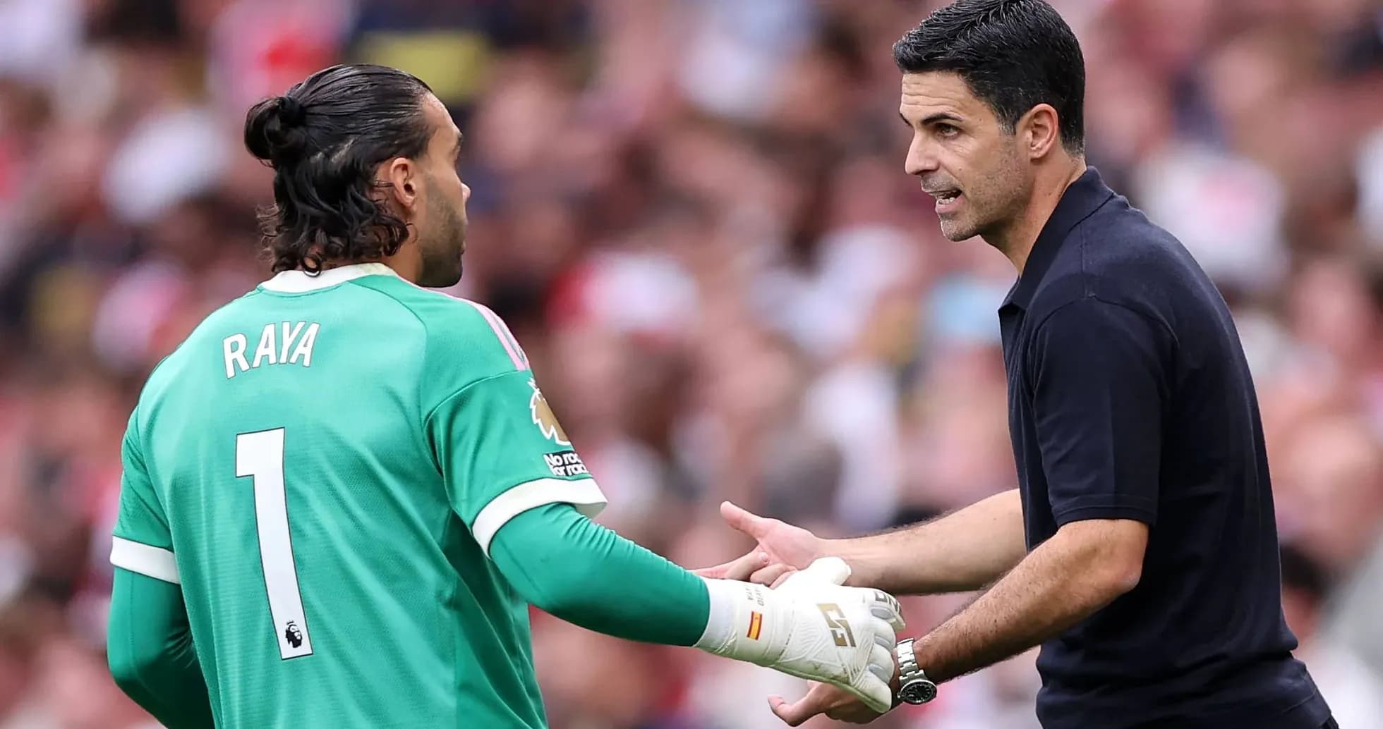 Goalkeeper Raya discussing strategy with manager Arteta