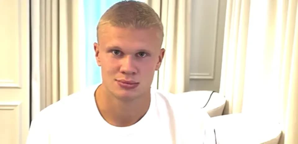 Athlete sitting in a room wearing a white shirt