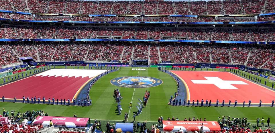 Qatar and Switzerland flags on the pitch