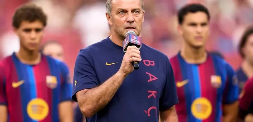 Coach speaking at event with players in background