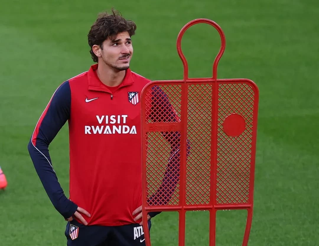 Player standing beside training dummy during practice