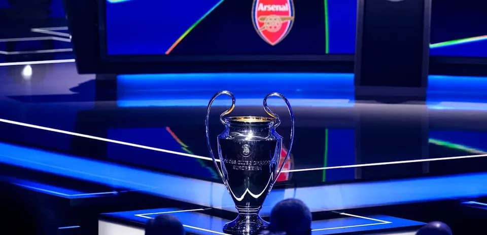 UEFA Champions League trophy on display with Arsenal logo