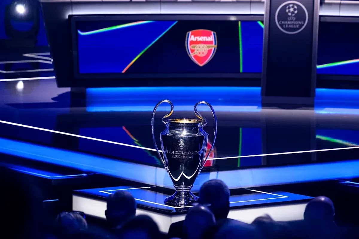 UEFA Champions League trophy on display with Arsenal logo