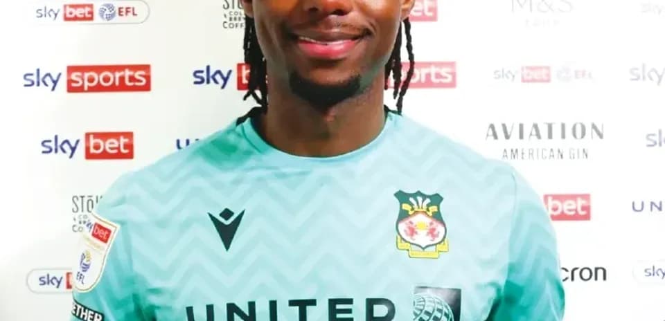 Goalkeeper posing in club jersey with sponsor logos