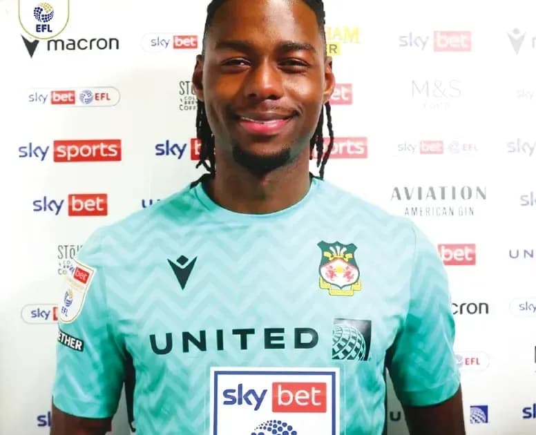Goalkeeper posing in club jersey with sponsor logos