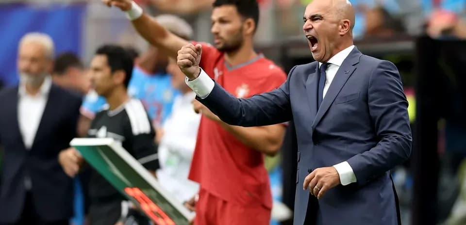 Coach gesturing passionately on the sidelines during match