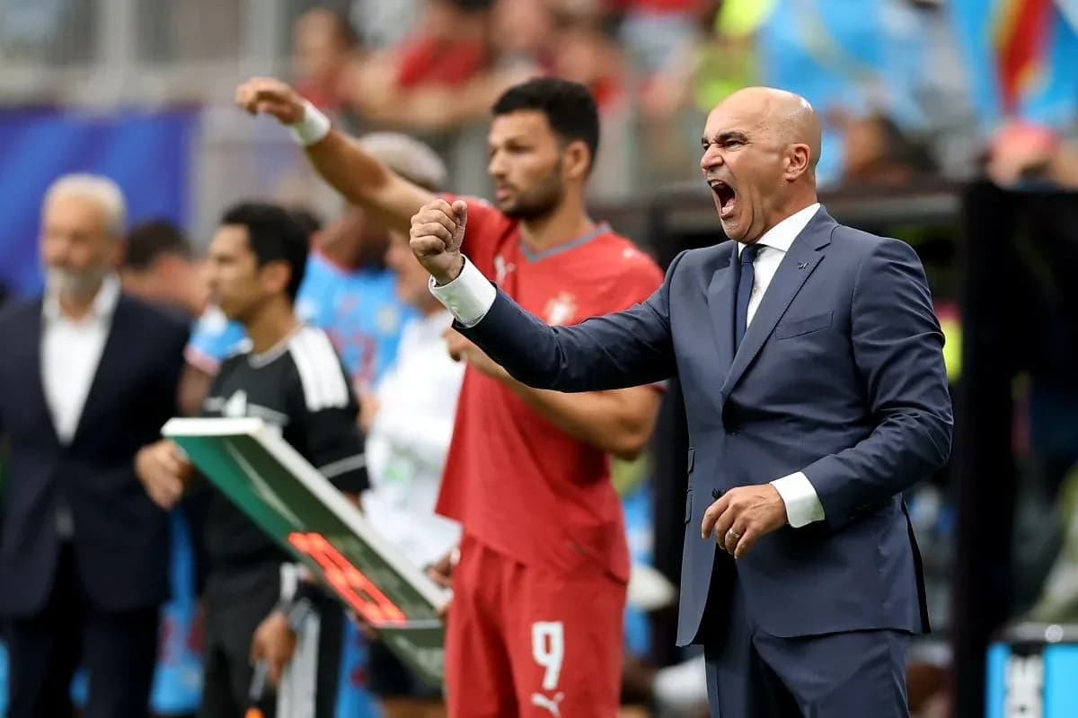 Coach gesturing passionately on the sidelines during match