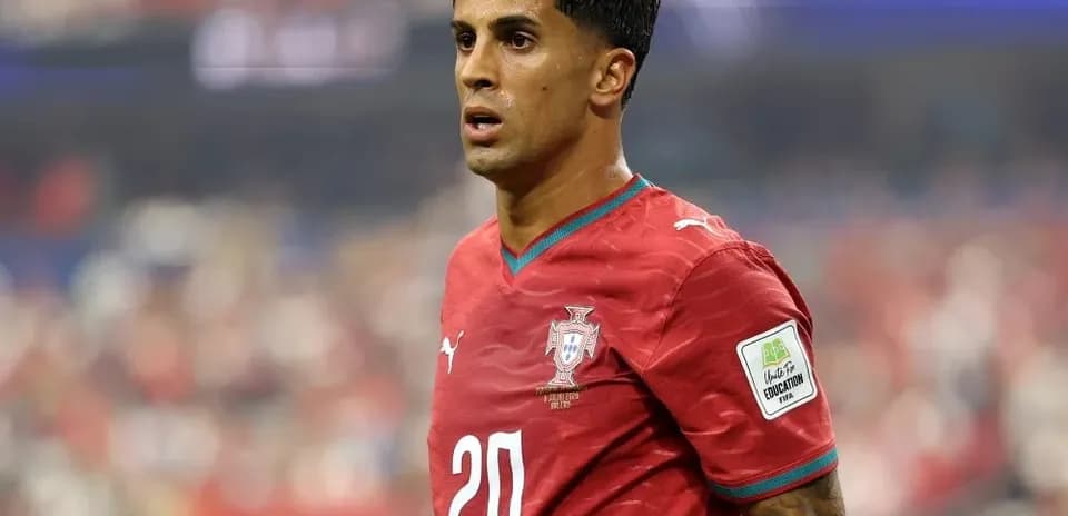 Player in red jersey during match on field