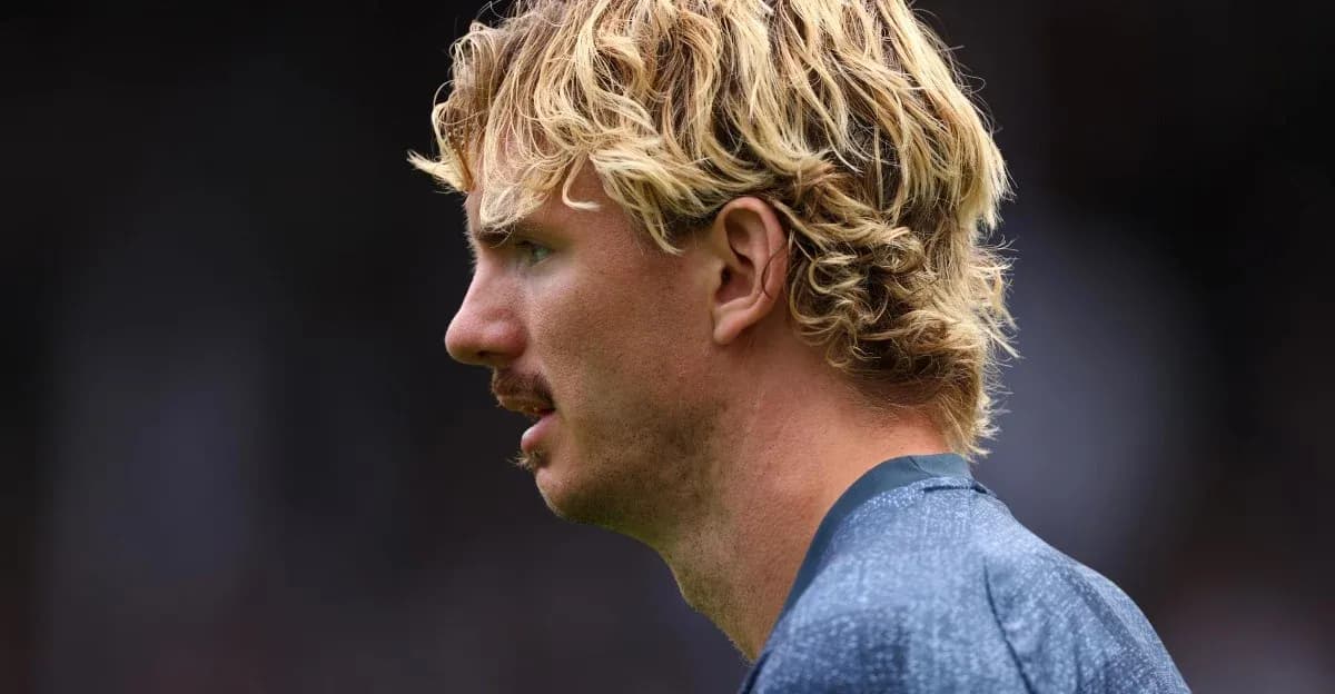Player with curly blonde hair in profile view