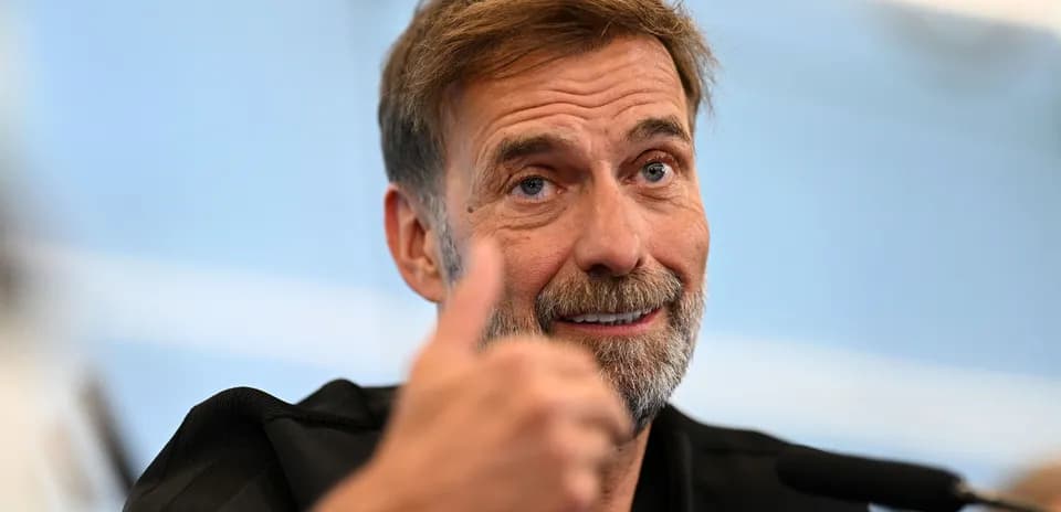 Manager giving thumbs up during press conference