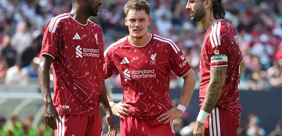 Liverpool players discussing strategy on the field