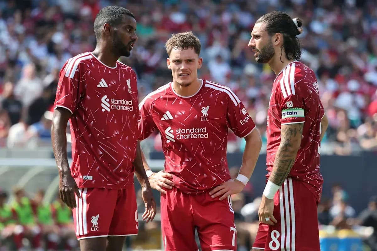 Liverpool players discussing strategy on the field