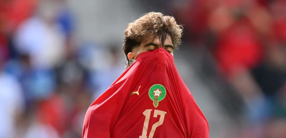 Player in red jersey pulling shirt over face
