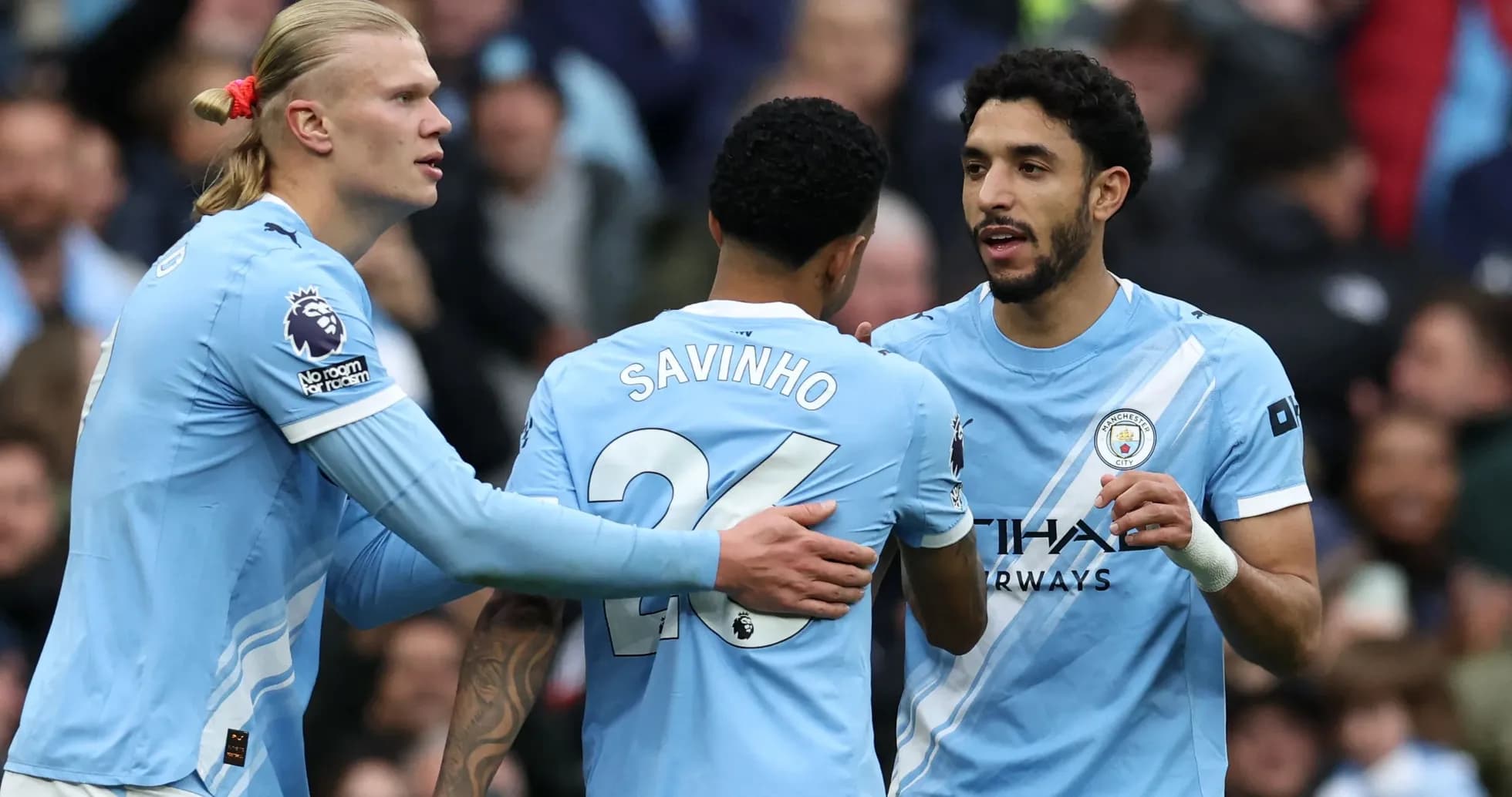 Manchester City players celebrating a goal on pitch