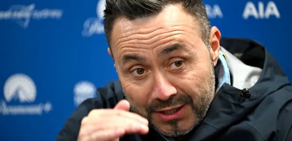 Manager speaking at press conference with hand gestures