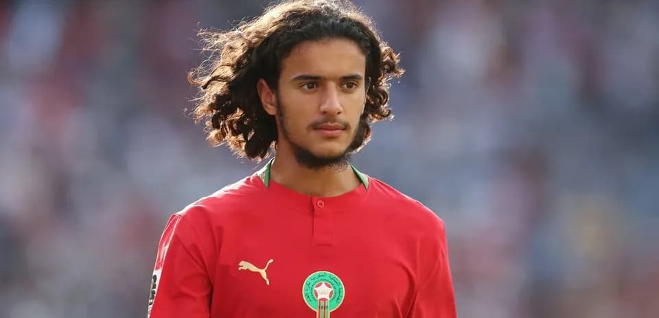 Player in red jersey during match warm-up