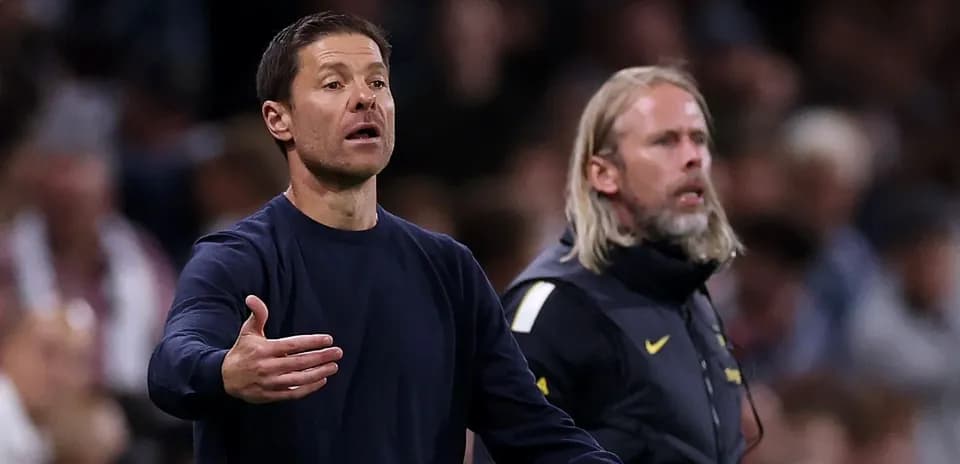 Coaches gesturing from the sidelines during match