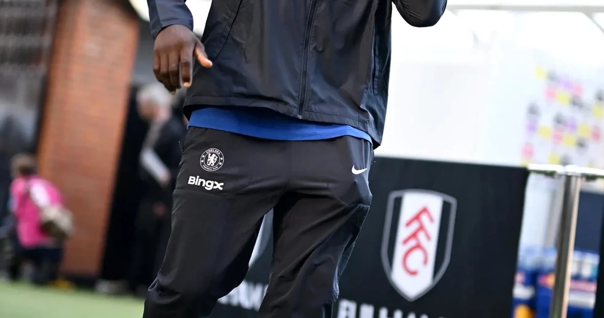 Player walking towards stadium entrance before match