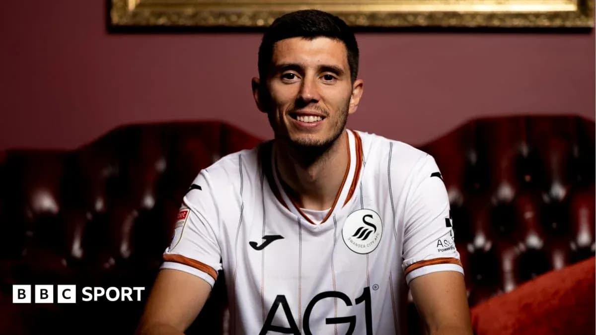 Player in Swansea City jersey smiling for photo