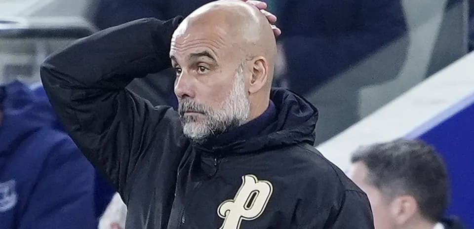 Coach with hand on head during match