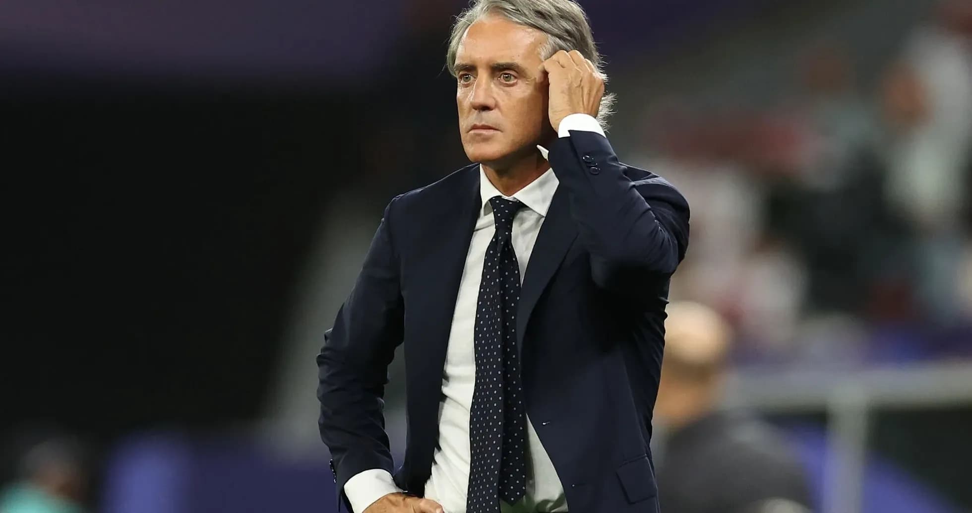 Coach observing match with hand on head