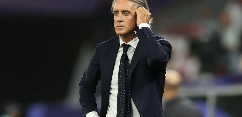 Coach observing match with hand on head