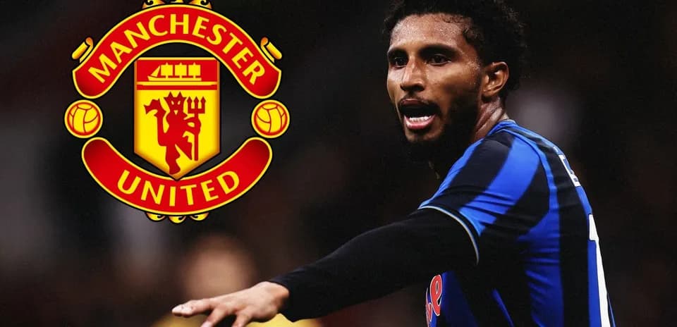 Player gesturing on field with Manchester United logo